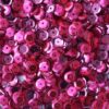 Pink pailletter 6 mm, 500 stk., skinnende runde palietter spredt foran en skål.