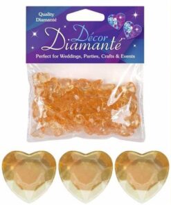 Pose med guldhjerte-pynte diamanter og tre store facetterede guldhjerter foran.