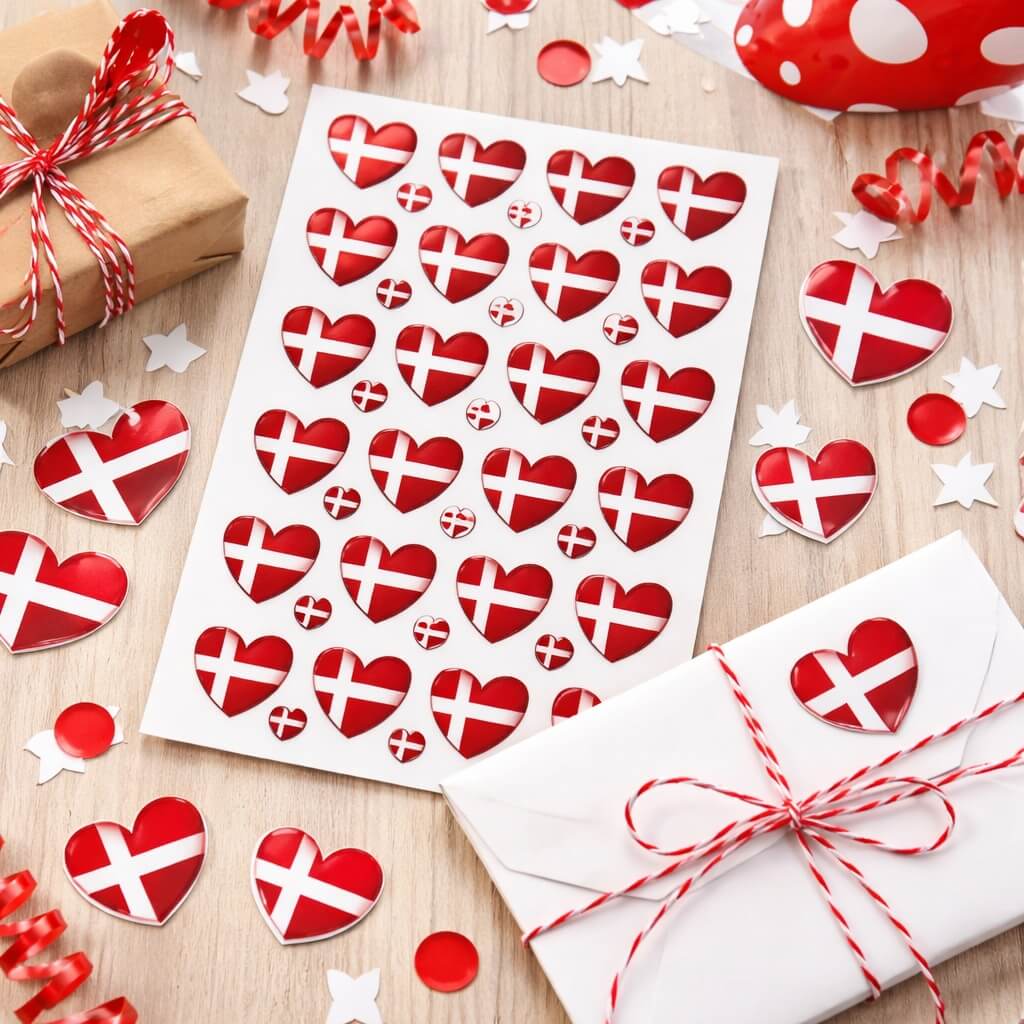 Hjerteformede Dannebrog stickers brugt på gave, invitation og konvolut til studenterfest med rød hvid festdekoration