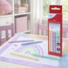 Faber-Castell Jumbo Grip pastel farveblyanter i brug på børnebord med regnbuetegning og produktæske i baggrunden